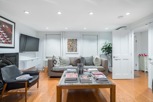 17E 128th St, New York Manhattan, NY 10035 - living area featuring radiator heating unit, light wood-type flooring, recessed lighting, and a fireplace