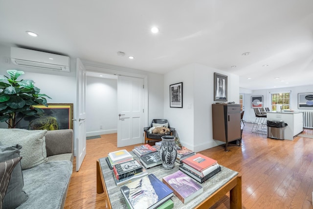 17E 128th St, New York Manhattan, NY 10035 - living room with an AC wall unit, light wood-style floors, and recessed lighting