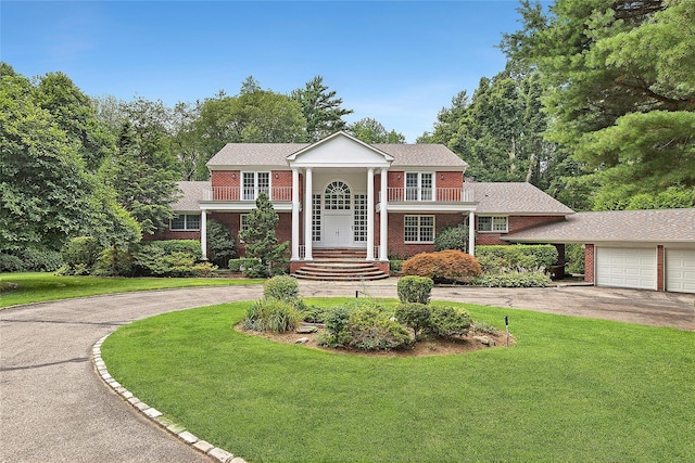 14 Pheasant Hill Ln, Old Brookville, NY 11545 - greek revival house featuring concrete driveway, a front yard, and brick siding