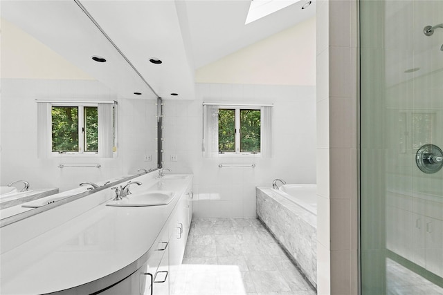 14 Pheasant Hill Ln, Old Brookville, NY 11545 - bathroom with tile walls, a skylight, double vanity, a garden tub, and vaulted ceiling