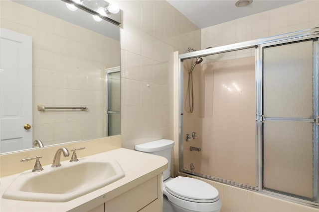 14 Pheasant Hill Ln, Old Brookville, NY 11545 - bathroom with tile walls, bath / shower combo with glass door, and vanity