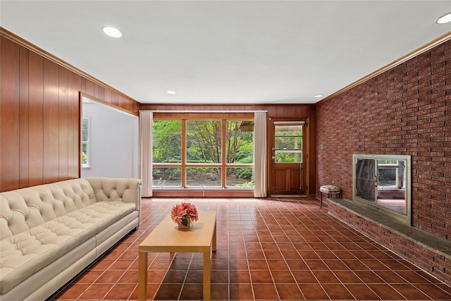 14 Pheasant Hill Ln, Old Brookville, NY 11545 - tiled living area with crown molding, wood walls, a brick fireplace, recessed lighting, and brick wall