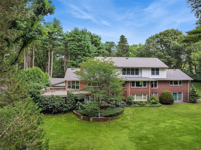14 Pheasant Hill Ln, Old Brookville, NY 11545 - rear view of house with brick siding, a lawn, a deck, and view of wooded area