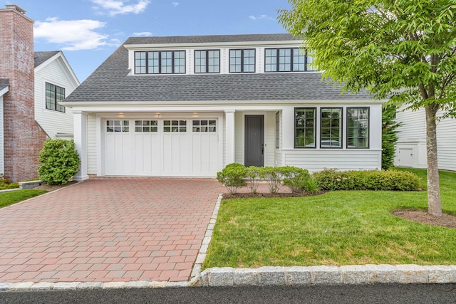 7 Honeysuckle Ln, Rye Brook, NY 10573 - view of front facade with a shingled roof, a front yard, decorative driveway, and a garage