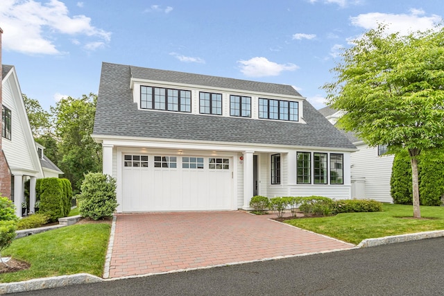 7 Honeysuckle Ln, Rye Brook, NY 10573 - view of front of house with a shingled roof, a front yard, decorative driveway, and an attached garage