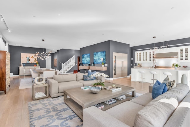 7 Honeysuckle Ln, Rye Brook, NY 10573 - living room featuring light wood-style floors, stairs, a chandelier, and recessed lighting