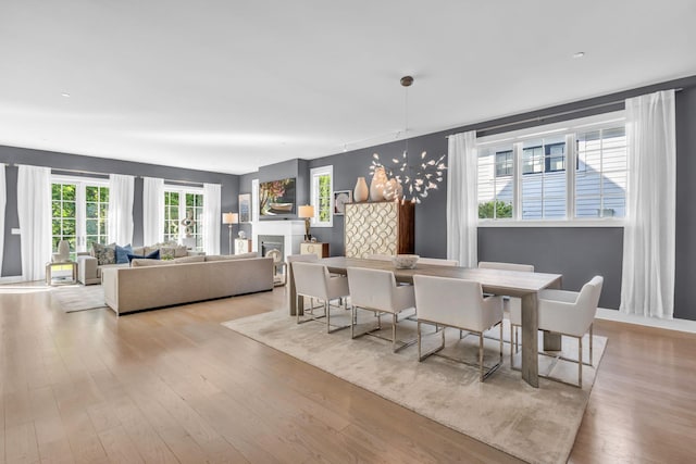 7 Honeysuckle Ln, Rye Brook, NY 10573 - dining space featuring wood finished floors and a fireplace