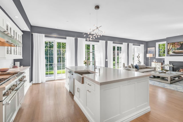 7 Honeysuckle Ln, Rye Brook, NY 10573 - kitchen featuring light wood finished floors, appliances with stainless steel finishes, white cabinets, light countertops, and recessed lighting