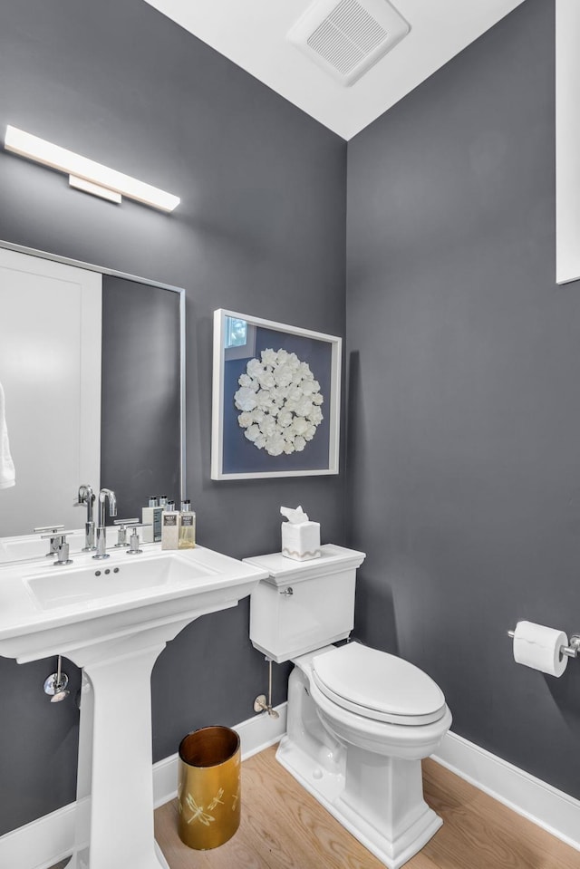 7 Honeysuckle Ln, Rye Brook, NY 10573 - half bathroom featuring wood finished floors and toilet