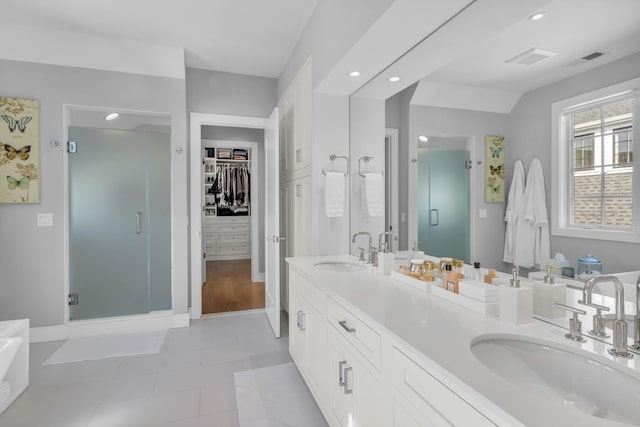 7 Honeysuckle Ln, Rye Brook, NY 10573 - full bath with a shower stall, double vanity, a walk in closet, tile patterned floors, and recessed lighting