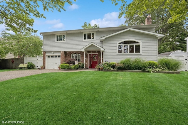 9 Fern Dr W, Jericho, NY 11753 - view of front of house with an attached garage, a chimney, brick siding, and driveway
