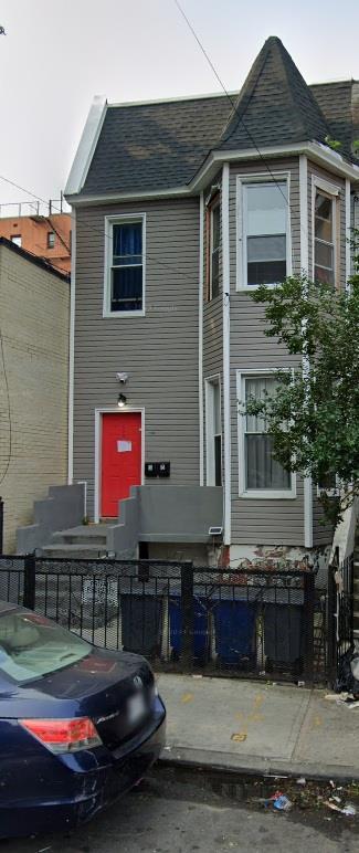 130 W 165th St, Bronx, NY 10452 - view of front of property with a fenced front yard