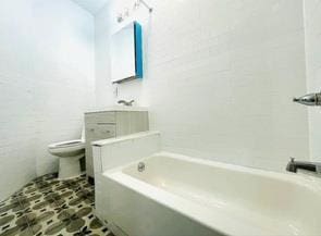 130 W 165th St, Bronx, NY 10452 - bathroom with a tub and vanity