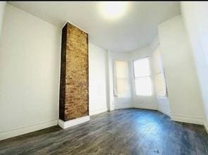 130 W 165th St, Bronx, NY 10452 - unfurnished living room with baseboards and wood finished floors