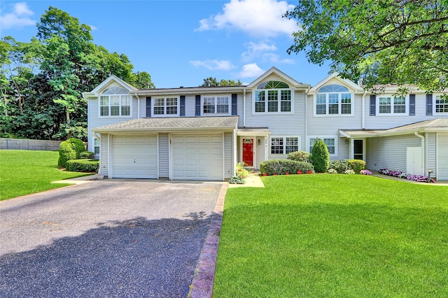 23 Indian Trce, Kings Park, NY 11754 - traditional home featuring asphalt driveway, a garage, and a front lawn