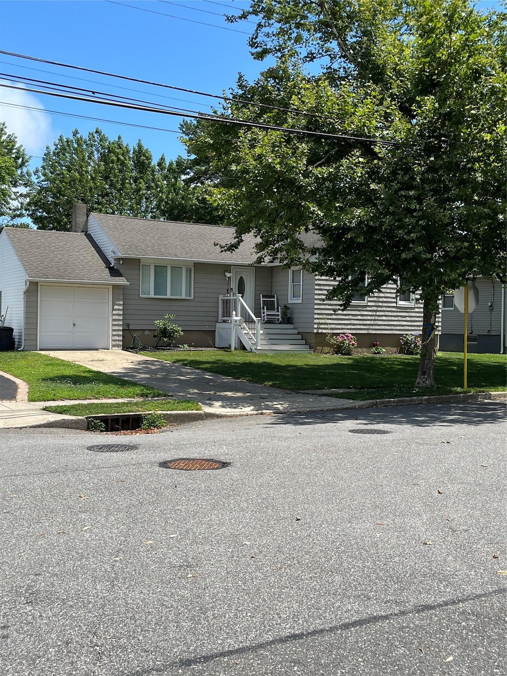 19 Tappan Ave, Babylon, NY 11702 - view of front of house featuring an attached garage and driveway
