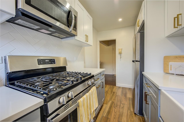 144-60 Gravett Rd Unit 4J, Kew Garden Hills, NY 11367 - kitchen featuring appliances with stainless steel finishes, backsplash, light countertops, wood finished floors, and recessed lighting