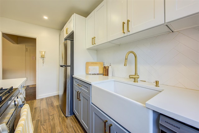 144-60 Gravett Rd Unit 4J, Kew Garden Hills, NY 11367 - kitchen with appliances with stainless steel finishes, tasteful backsplash, light countertops, white cabinets, and wood finished floors