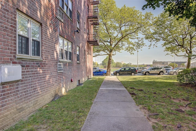 144-60 Gravett Rd Unit 4J, Kew Garden Hills, NY 11367 - view of side of home with brick siding and a lawn