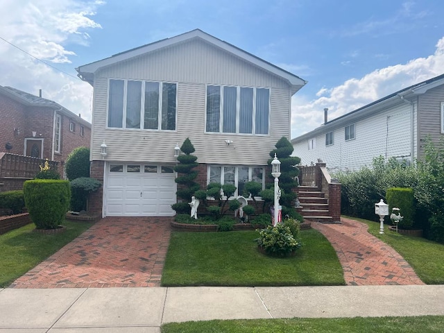 15916 92nd St, Howard Beach, NY 11414 - view of front of house featuring decorative driveway, an attached garage, a front yard, brick siding, and stairs