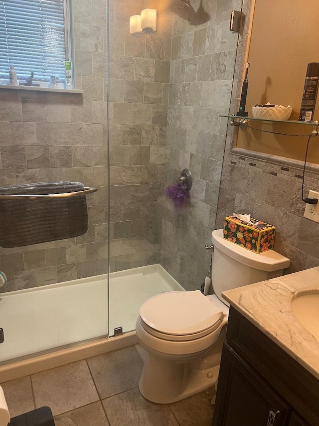 15916 92nd St, Howard Beach, NY 11414 - bathroom featuring tile walls, vanity, a stall shower, and tile patterned floors