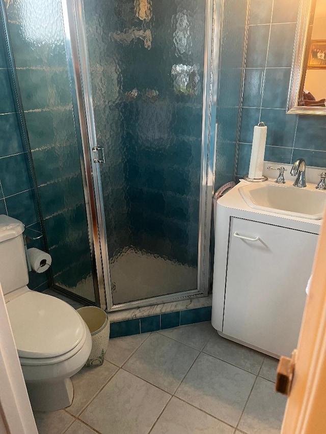15916 92nd St, Howard Beach, NY 11414 - full bath with vanity, tile patterned floors, a shower stall, and tile walls