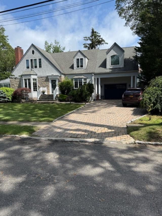 9 Seneca St E, Massapequa, NY 11758 - cape cod home featuring decorative driveway, a front lawn, a garage, and a chimney