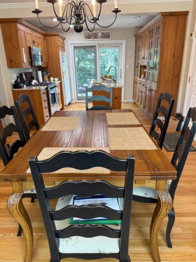 9 Seneca St E, Massapequa, NY 11758 - dining room featuring a chandelier, light wood-style floors, and ornamental molding