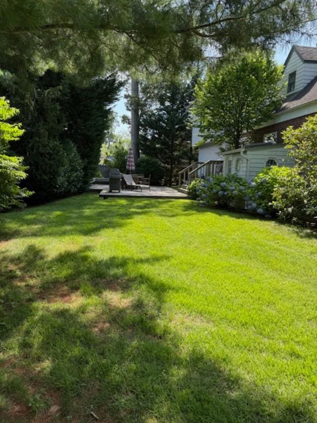9 Seneca St E, Massapequa, NY 11758 - view of grassy yard featuring a patio