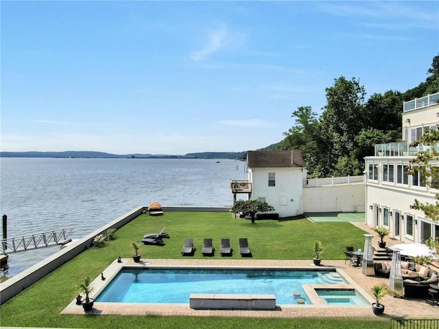 74 River Rd, Nyack, NY 10960 - view of pool with a water view, a yard, a pool with connected hot tub, and a storage shed
