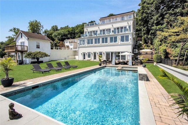 74 River Rd, Nyack, NY 10960 - back of house featuring a balcony, a patio area, and a pool with connected hot tub