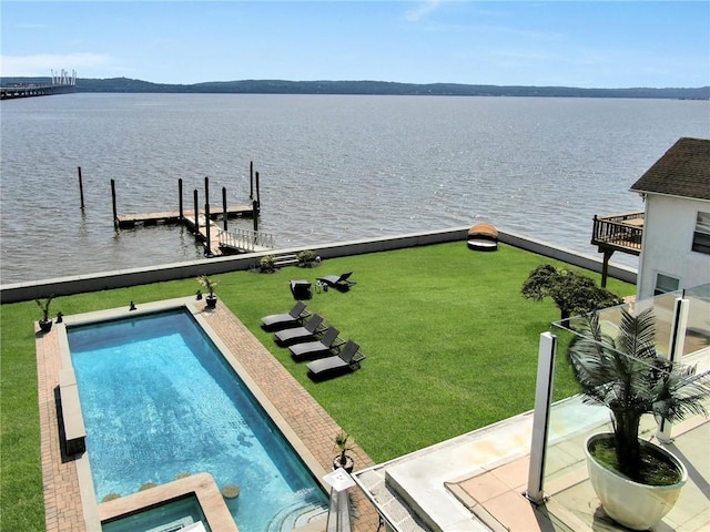 74 River Rd, Nyack, NY 10960 - view of swimming pool with a water view, a boat dock, a lawn, and a pool with connected hot tub