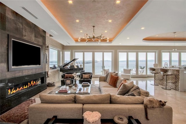 74 River Rd, Nyack, NY 10960 - living room with a tray ceiling, plenty of natural light, a chandelier, a fireplace, and recessed lighting