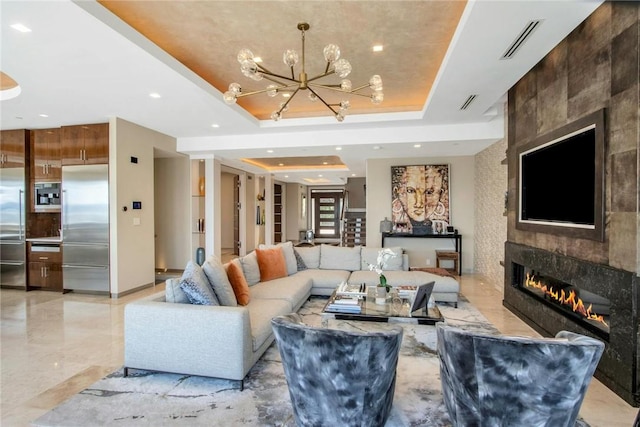 74 River Rd, Nyack, NY 10960 - living area with a fireplace, a raised ceiling, a chandelier, recessed lighting, and light marble finish floors
