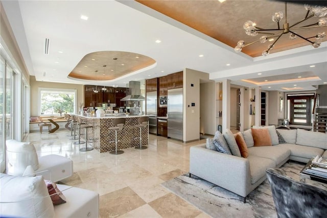 74 River Rd, Nyack, NY 10960 - living room with a tray ceiling, recessed lighting, and a chandelier