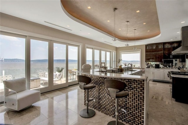 74 River Rd, Nyack, NY 10960 - kitchen featuring a tray ceiling, a kitchen breakfast bar, recessed lighting, extractor fan, and a large island