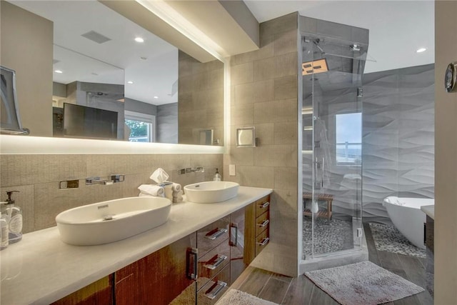 74 River Rd, Nyack, NY 10960 - full bath with tile walls, a shower stall, a freestanding tub, double vanity, and backsplash