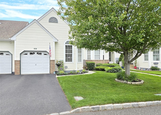 507 Constance Ln, Port Jefferson Station, NY 11776 - view of front of house featuring a front lawn, asphalt driveway, a garage, and brick siding