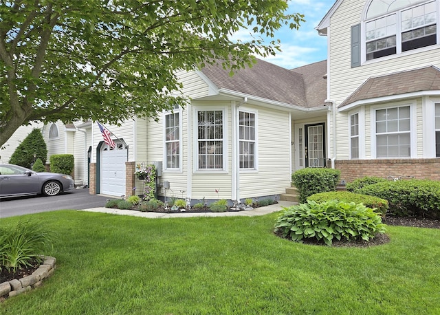507 Constance Ln, Port Jefferson Station, NY 11776 - view of home's exterior with a shingled roof, a lawn, asphalt driveway, and brick siding