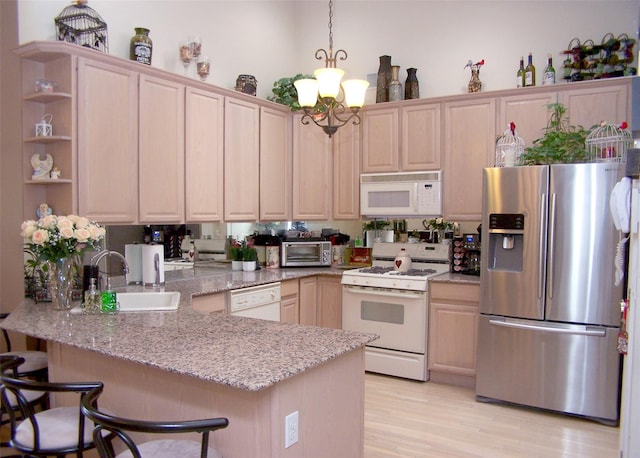 507 Constance Ln, Port Jefferson Station, NY 11776 - kitchen featuring white appliances, a peninsula, a chandelier, light stone countertops, and light wood-style flooring