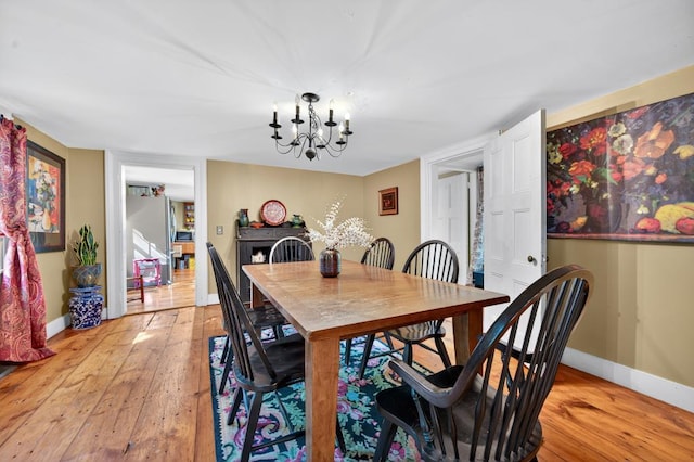35 Everett Rd, Goshen, NY 10916 - dining space with light wood-type flooring and a chandelier