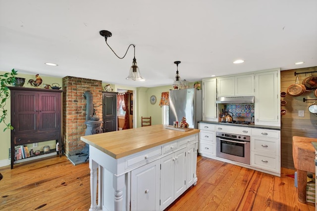35 Everett Rd, Goshen, NY 10916 - kitchen with stainless steel appliances, under cabinet range hood, light wood-style flooring, butcher block countertops, and hanging light fixtures