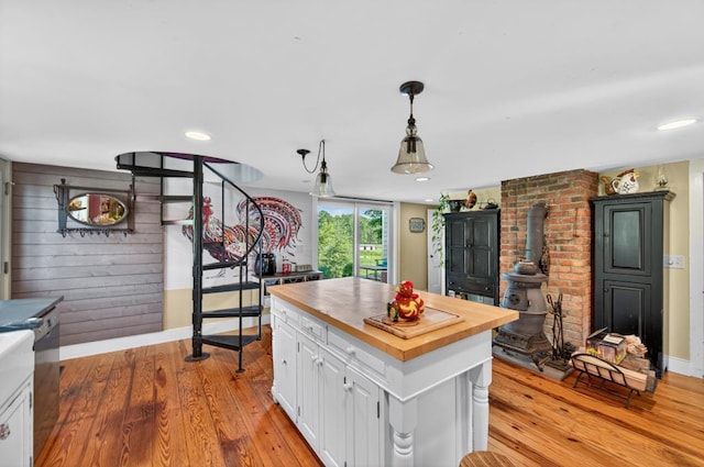 35 Everett Rd, Goshen, NY 10916 - kitchen with wooden counters, a wood stove, light wood-type flooring, white cabinetry, and recessed lighting