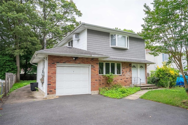 7 Miller Dr, Lake Grove, NY 11755 - traditional-style house featuring an attached garage, driveway, a wall unit AC, and roof with shingles