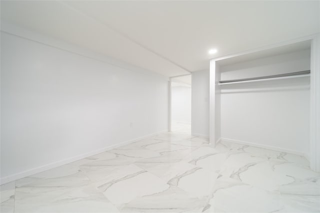7 Miller Dr, Lake Grove, NY 11755 - unfurnished bedroom with a closet, light marble finish flooring, and recessed lighting