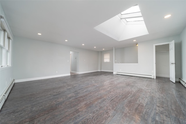 7 Miller Dr, Lake Grove, NY 11755 - empty room with baseboard heating, a skylight, dark wood finished floors, and recessed lighting