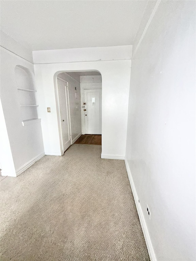 61-41 Saunders St Unit B44, Rego Park, NY 11374 - unfurnished room with arched walkways and light carpet