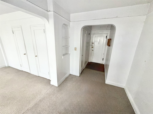 61-41 Saunders St Unit B44, Rego Park, NY 11374 - hallway featuring carpet floors and arched walkways