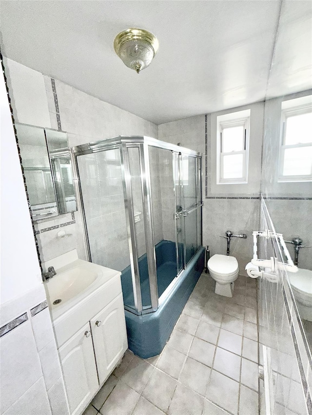 61-41 Saunders St Unit B44, Rego Park, NY 11374 - full bath featuring vanity, tile patterned flooring, tile walls, and shower / bath combination with glass door