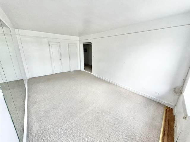 61-41 Saunders St Unit B44, Rego Park, NY 11374 - unfurnished bedroom with arched walkways and light colored carpet